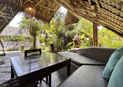 Cottage seating and dining area, ideal for room service breakfast, surrounded by tropical gardens.