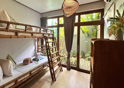 Bedroom 2 with bespoke bamboo bunkbed and garden view.