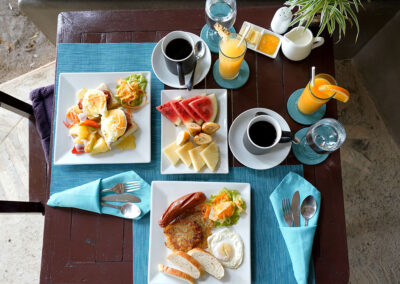 Room service cooked breakfast, fruit, coffee and juice, served outside cottage at Buko Beach Resort.