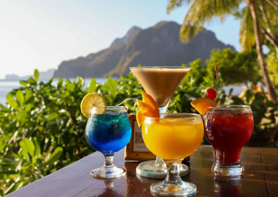 Tropical cocktails with a sea view, during happy hour at Buko Beach Restaurant and Bar