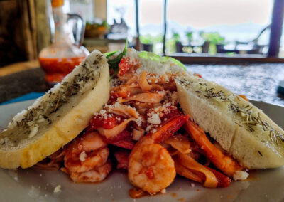 Prawn pasta with garlic bread served with a sea view at Buko Beach Restaurant.