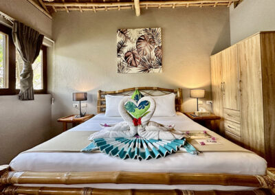 Loft studio king-sized bed with towels designed in a heart for romantic retreat.