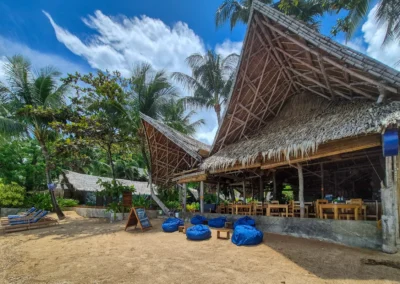Beachfront view of restaurant and bar, with bean bags to relax while watching sunset.