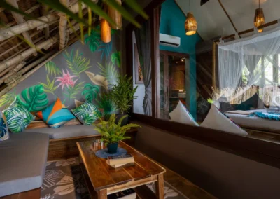 Cottage outdoor seating area with electric fan, ideal for reading or just relaxing, surrounded by tropical gardens