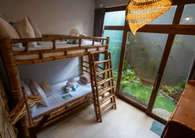 Bedroom 2 with bespoke bamboo bunkbed and garden view.