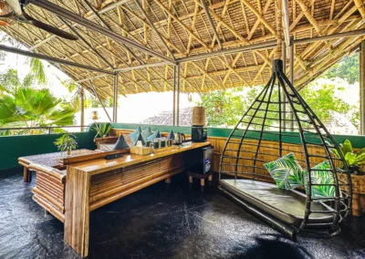 Beachfront Pool Villa spacious balcony with seating area, coffee/tea station and bamboo swinging egg chair