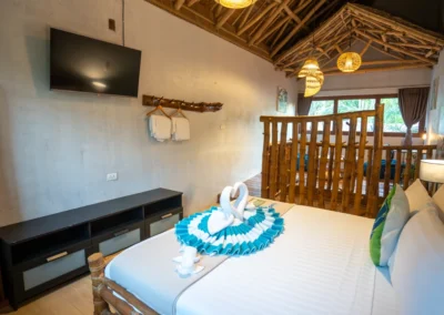 Bedroom 2 with bespoke bamboo bunkbed and garden view.