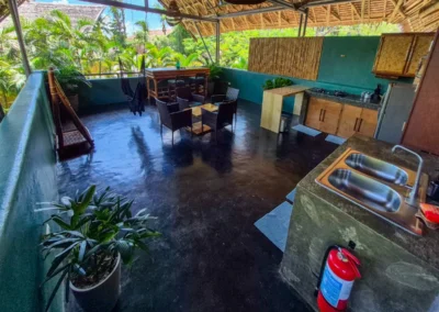 Loft studio balcony surrounded by tropical gardens.